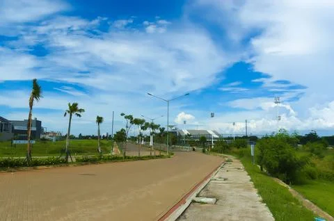 Empty street in a residential complex set against a backdrop of thick cloud.. Stock Photos