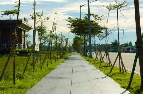 Empty street in a residential complex set against a backdrop of thick cloud.. Stock Photos