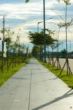 Empty street in a residential complex set against a backdrop of thick cloud.. Stock Photos
