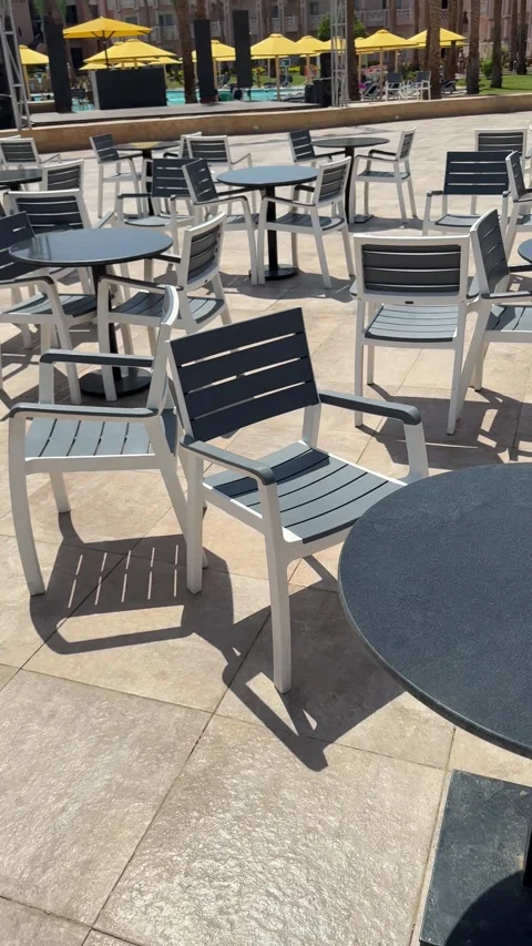 An empty street restaurant features tables and chairs in disarray, with no cu Stock Footage 282801960