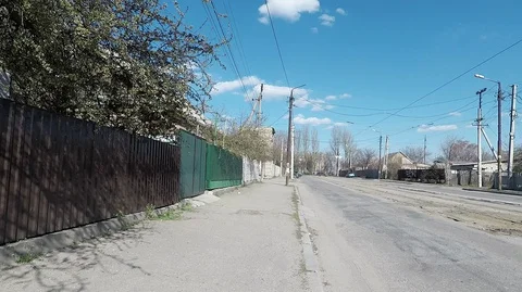 Empty street of a small poor town with bad roads and sidewalks during quarantine Stock Footage 127683680