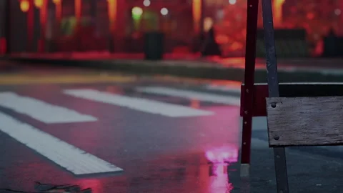 Empty street with a wet surface at night near bright red lights Stock Footage 342038740