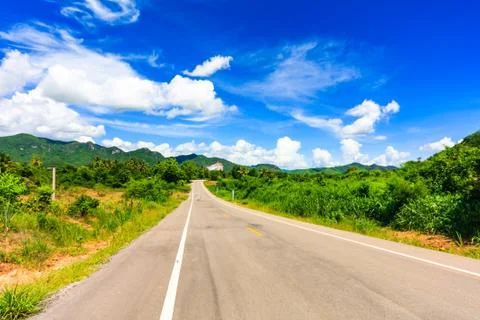 Empty stretch of road into the hills Stock Photos