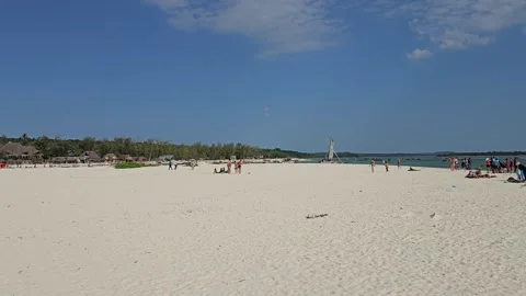 Empty Stretch of White Sand Beach Under Blue Sky, Kendwa, Zanzibar, Tanzania 8K Stock Footage 313907427