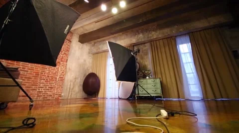 Empty studio with bed, stylish armchair and equipment for shooting Vídeo Stock 62135711