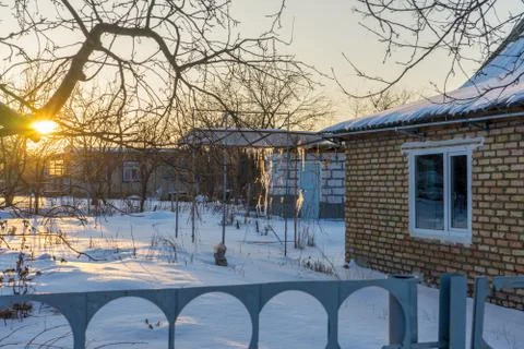 Empty suburban plot covered with snow and left for the winter brick cottage h Stock Photos