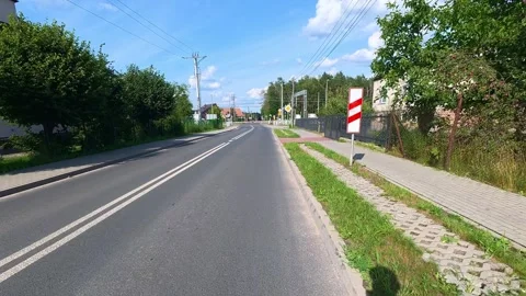 Empty suburban road stretching through residential neighborhood on sunny da.. Stock Footage 341974640