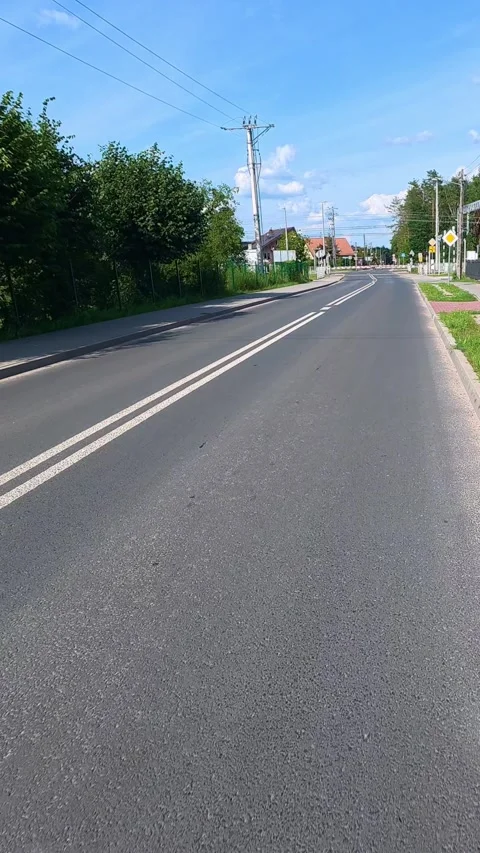 Empty suburban road stretching through residential neighborhood on clear da.. Stock Footage 341974654