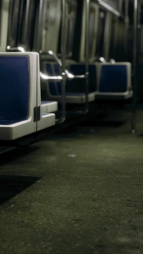 Empty subway car interior shows seats and floor in low light Stock Footage 334259744