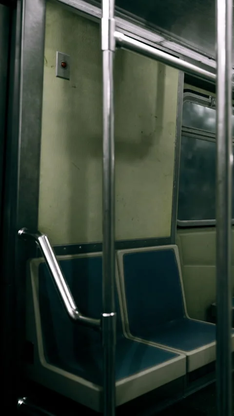Empty subway car with metallic poles and dark interior during late hours Stock Footage 334171738