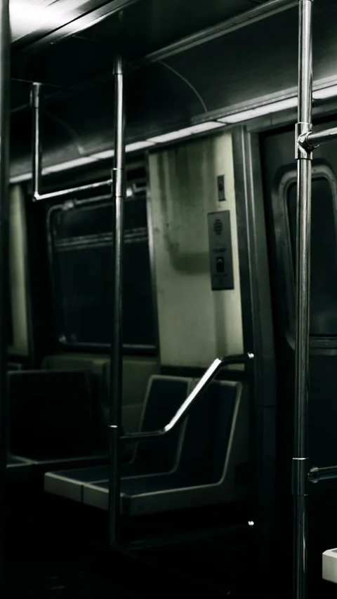 Empty subway car at night with metal poles and seats in focus Stock Footage 334172043