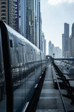 Empty subway platform with modern train waiting at station in dubai Stock Photos