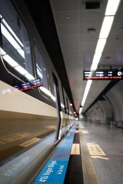 Empty subway platform with train doors and safety markings, vertical Stock Photos