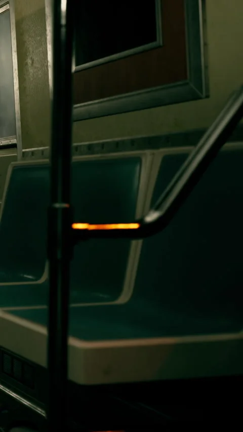 Empty subway seats with a rail in a dimly lit train carriage at night Video stock 340636673