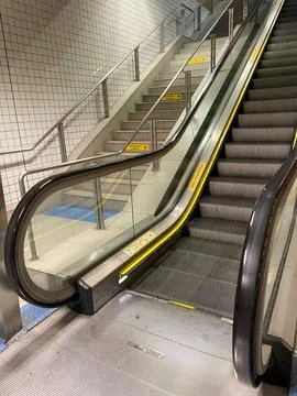 Empty subway station escalator Stock Photos