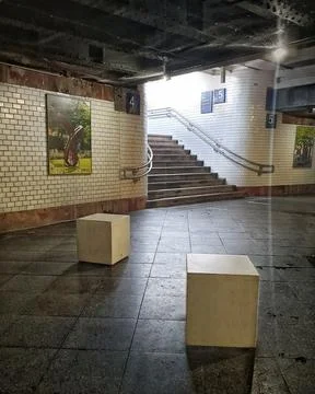 Empty subway station platform with stairs and white tiled walls Stock Photos