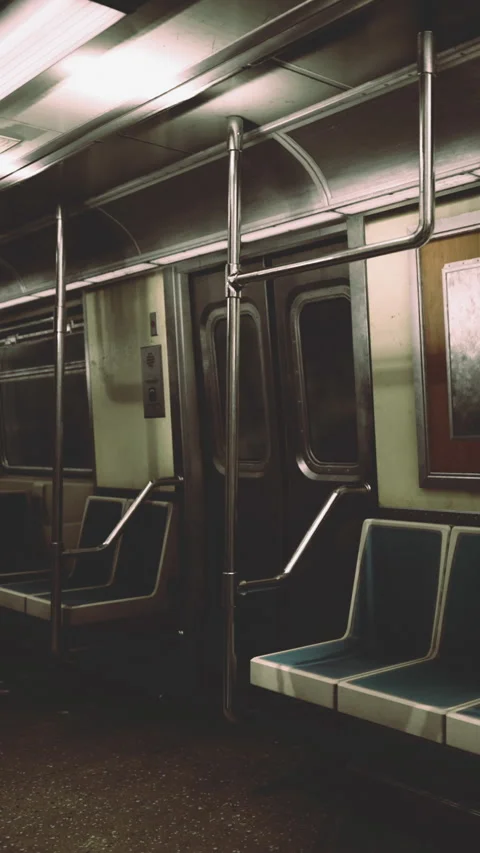 Empty subway train interior during evening hours with metal poles and seats Stock Footage 334889285