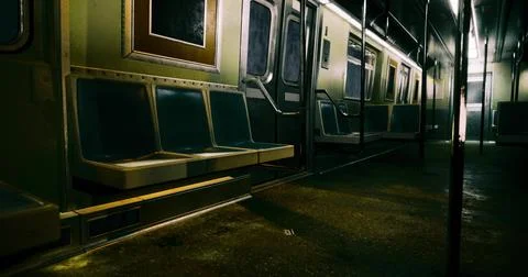 Empty subway train interior at night with dim lighting and old design Stock Illustration