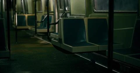 Empty subway train interior with retro seating and dim lighting at night Stock Illustration