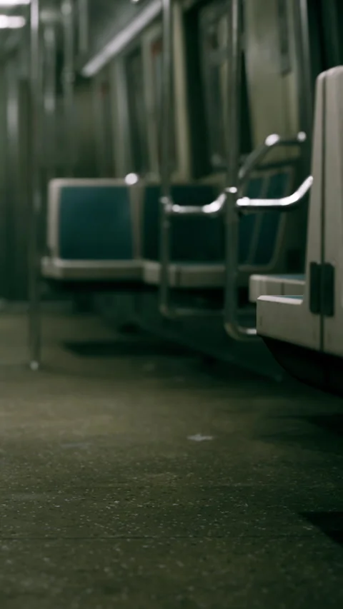 Empty subway train interior with seats and floor in dark setting during day Stock Footage 338415689