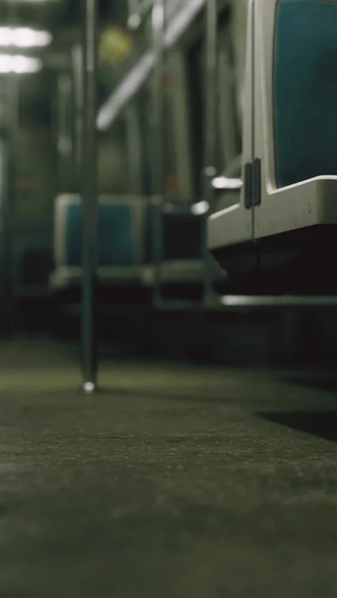 Empty subway train with seats and floor visible in a dimly lit environment Stock Footage 334049276