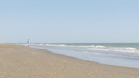 Empty summer beach with a man walking. Brussa beach, Caorle, Italy Видео 84027466