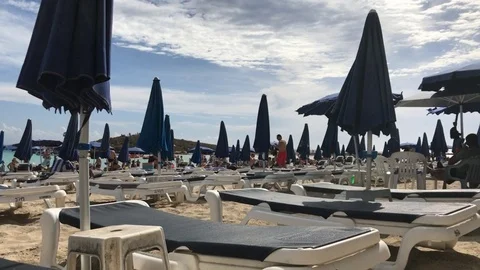 Empty Sun Beds at the Beach with a cloudy sky Stock Footage 91204467