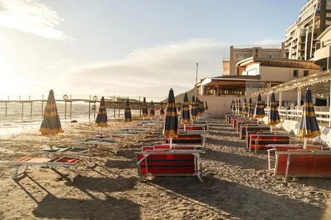 Empty sun beds on the beach during a pandemic coronavirus. Deserted beach in Stock Photos