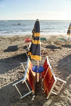 Empty sun beds on the beach during a pandemic coronavirus. Deserted beach in Stock Photos