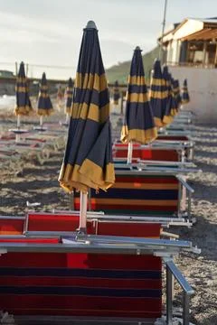 Empty sun beds on the beach during a pandemic coronavirus. Deserted beach in Stock Photos