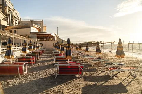 Empty sun beds on the beach during a pandemic coronavirus. Deserted beach in Stock Photos