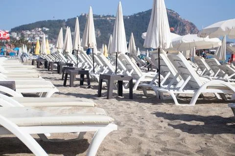 Empty sun beds on a beach Stock Photos