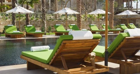 Empty sun loungers arranged in row at poolside Stock Footage 101200215