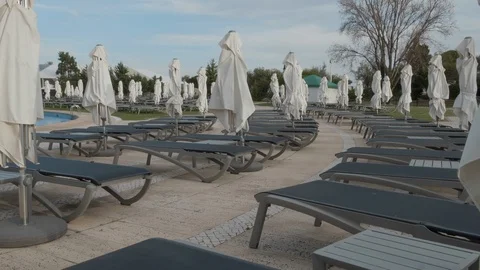 Empty sun loungers by pool Stock Footage 106497024