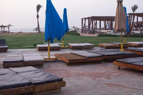Empty sun loungers with a soft surface on the beach. Stock Photos