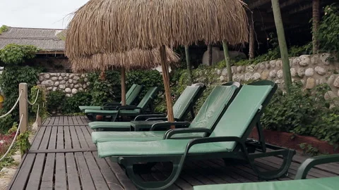 Empty sunbeds in an exotic beach in tropic thailand Stock Footage 100892739