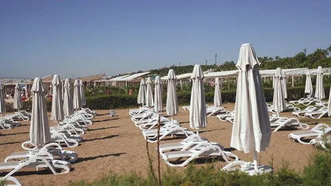 Empty sunny sandy beach and traditional beach equipment Stock Footage 164209088