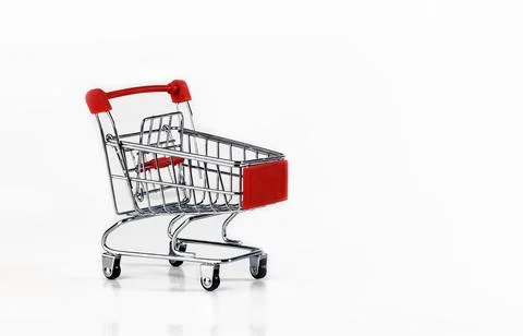 An empty supermarket cart with red inserts on a white background. Foto stock