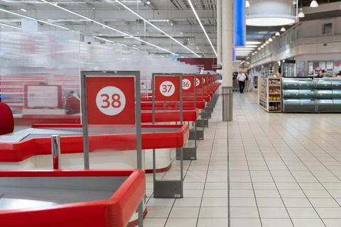 Empty supermarket checkout counters in a row inside retail grocery store. Stock Photos
