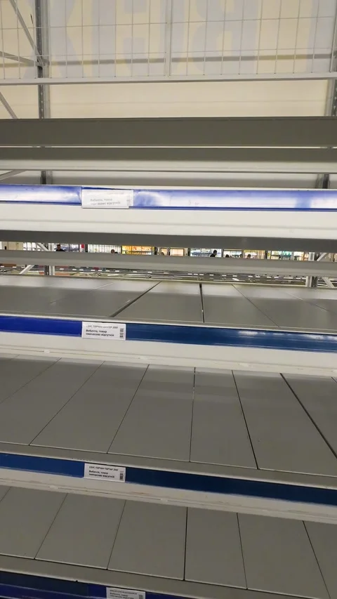 Empty supermarket shelves stand completely bare in a retail store.  Stock Footage 346654009