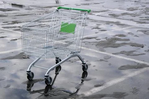 An empty supermarket trolley on wheels Stock Photos