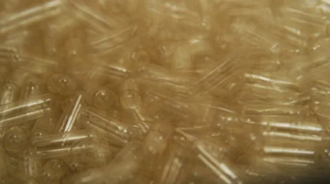 Empty Supplement Capsules being fed into a Production Machine Stock Footage 50032104