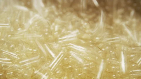Empty Supplement Capsules being fed into a Production Machine Stock Footage 50032382