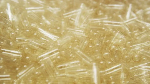 Empty Supplement Capsules being fed into a Production Machine Stock Footage 50054342