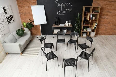Empty support group meeting room with chairs in circle Stock Photos