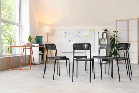 Empty support group meeting room with chairs in circle Stock Photos
