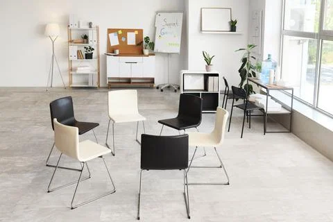 Empty support group meeting room with chairs in a circle Stock Photos