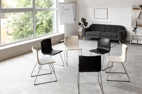 Empty support group meeting room with chairs arranged in circle Stock Photos