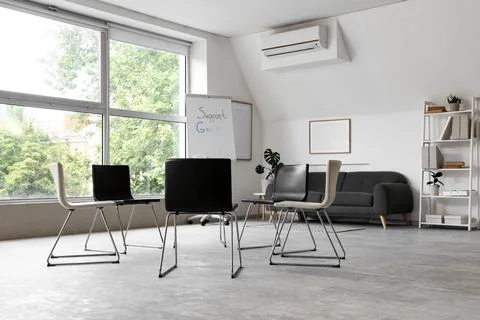 Empty support group meeting room with chairs in circle Stock Photos