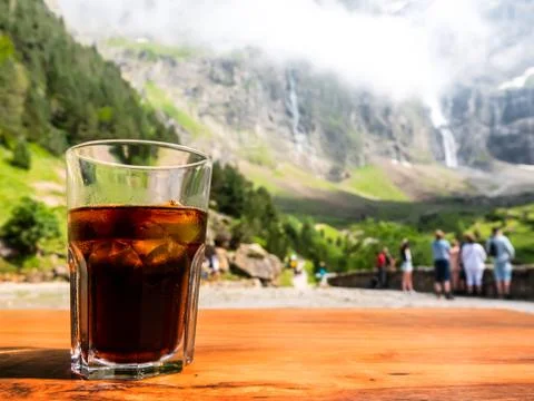 Empty surface of a wooden table overlooking the path leading to the mountains Stock Photos